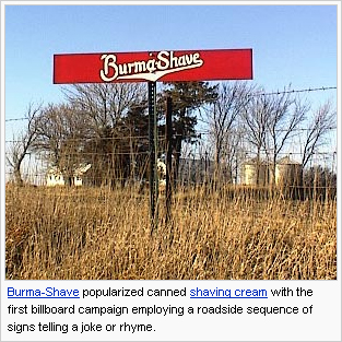 Small red sign with Burma Shave logo, near a fence in a field