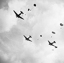 Three aircraft with parachutists leaving from the doors