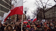 Protestors in Warsaw waving Polish and European flags