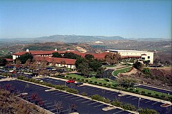 Over view of the library and parking lot nestled in the hills