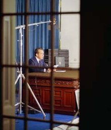 A view of President Nixon at the Wilson desk as seen though a window into the Oval Office.