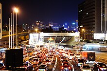 Tunnel entrance at night, with heavy traffic