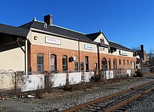 A reused railway station next to a single track
