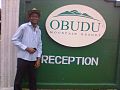 A man posing by the reception post of Obudu Mountain Resort