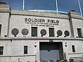 Exterior of Soldier Field, with a sign reading "Dedicated to the men and women of the armed services"