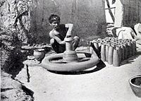 A potter with his pottery wheel, British Raj (1910)