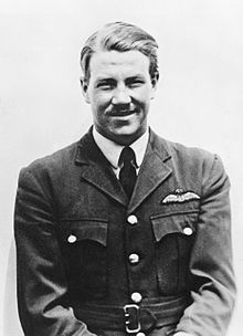 Portrait of man in dark military uniform with pilot's wings