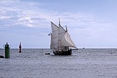 Photo shows a two-masted sailboat.
