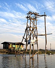 Wooden lattice transmission tower in Inle Lake (Myanmar).