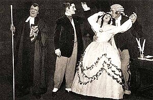 A sepia photo showing four characters, the Usher, the Defendant and the Plaintiff swooning in the arms of the Judge.