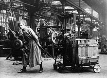 A female worker demonstrates a machine which can lift boxes to save physical labour at the Bowling Iron Works, Bradford, in November 1918