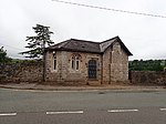 Small stone building at cemetery entrance