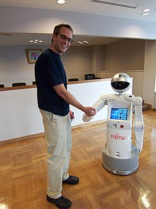 A man is shaking hands with a bot
