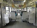 Interior of 209-2100 series car with transverse seating in June 2012