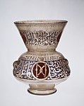 Mosque lamp; c. 1285; glass, enamels and gold; height: 26.4 cm; Metropolitan Museum of Art[54]