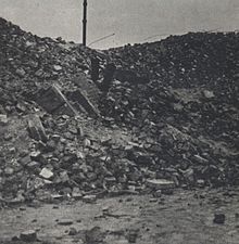 A heap of bricks on the place of what was a residential building. The photo shows one of the places where people were executed.