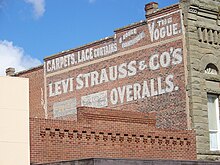 photo of a sign advertising Levi Strauss & Co. painted on a brick wall in Woodland, California