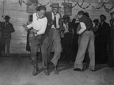 Social dance – dancers at a juke joint dance the Jitterbug, an early 20th century dance that would go on to influence swing, jive, and jazz dance.