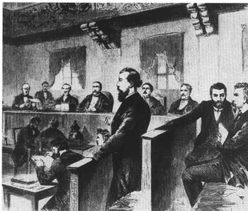 August Bebel (erster von rechts) und Wilhelm Liebknecht (Mitte stehend) werden in Leipzig wegen ihrer Opposition gegen den Deutsch-Französischen Krieg wegen Hochverrats verurteilt