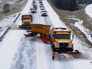 Trucks plowing snow on a highway in Missouri