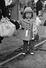 A child relocating to Owens Valley as part of the Japanese American internment, 1942