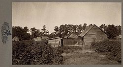 Old black-and-white photo of wooden shacks