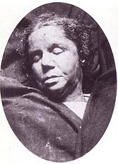 Mortuary photograph of McKenzie: a middle-aged woman with thick lips