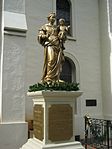 Statue of Our Lady of Peace with plaques in English, French, Portuguese, and Hawaiian with the words, "In memory of the first Roman Catholic Church, Our Lady of Peace 1827 to 1893."
