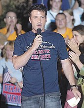 Ben Affleck speaking into a microphone while wearing a Kerry/Edwards campaign tshirt