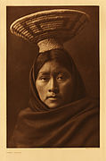 Luzi (Tohono O'odham) with coiled burden basket, with a supporting ring of yucca, photo by Edward S. Curtis