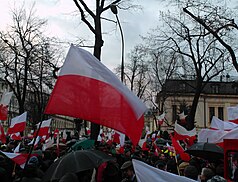 Protestors in Warsaw waving Polish flags