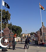 A tourist in front of the Wagah border post, on the Pakistani side, looking towards Attari on the Indian side.