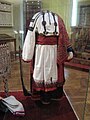 An example of Russian festive folk dress, including a rubakha (shirt), poneva (skirt), perednik (apron), and platok (shawl)