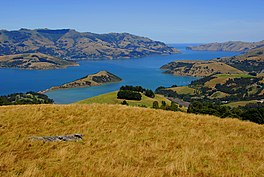 A photo of Akaroa Harbour from the northwest with Ōnawe Peninsula clearly visible