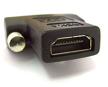 An adapter with an HDMI receptacle connector to DVI plug connector with a close up of the HDMI connector.