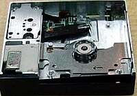 Dataplay optical drive engine internals viewed from above a unit produced without any top cover; above the circular piece is the laser pickup. The laser pickup is built on a piece of silicon. [15]