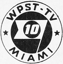 A black circle with a stylized white silhouette of a pennant-shaped flag in the center, a black circle within the flag contains the number "10" in an oblique serif font; outside of the main black circle is a white ring with the text "WPST-TV" on top and "MIAMI" on bottom, with two black stars separating the text.