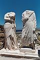 Statues of a woman and man wearing Ancient Greek himation
