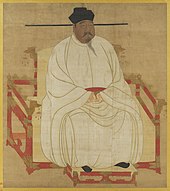Painted image of a portly man sitting in a red throne-chair with dragon-head decorations, wearing white silk robes, black shoes, and a black hat, and sporting a black mustache and goatee.