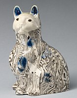 Cat, c. 1745, with agateware effects, and underglaze blue highlights