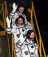 Borisenko, Garan, and Samokutyaev wave farewell from the bottom of the Soyuz rocket prior to their launch.