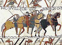 Horse riders wearing helmets and armor galloping through the midst of flying arrows.
