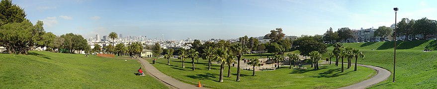 A panoramic view of Dolores Park, from the Muni stop near Twentieth and Church streets, with the San Francisco skyline in the distance