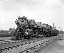 A black-and-white image of a large steam locomotive and tender