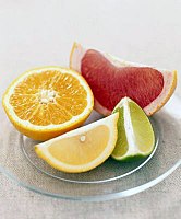 Wedges of pink grapefruit, lime, and lemon, and a half orange (clockwise from top)