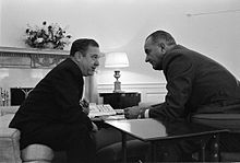Photograph of Senator Russell B. Long and Lyndon B. Johnson talking over a table