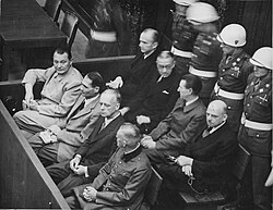 Defendants in the Nuremberg Trials sitting in the dock during proceedings. The Nuremberg defendants were charged primarily with war crimes and crimes against humanity related to Nazi Germany's conduct during දෙවන ලෝක යුද්ධය. Results ranged from acquittals to death sentences.
