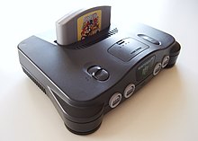 The Nintendo 64 console, with a cartridge partially visible inserted inside of it.