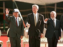 Clinton during the signing of the Israel–Jordan peace treaty, with Yitzhak Rabin (left) and King Hussein of Jordan (right)