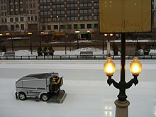 An ice resurfacing machine in action at a skating rink